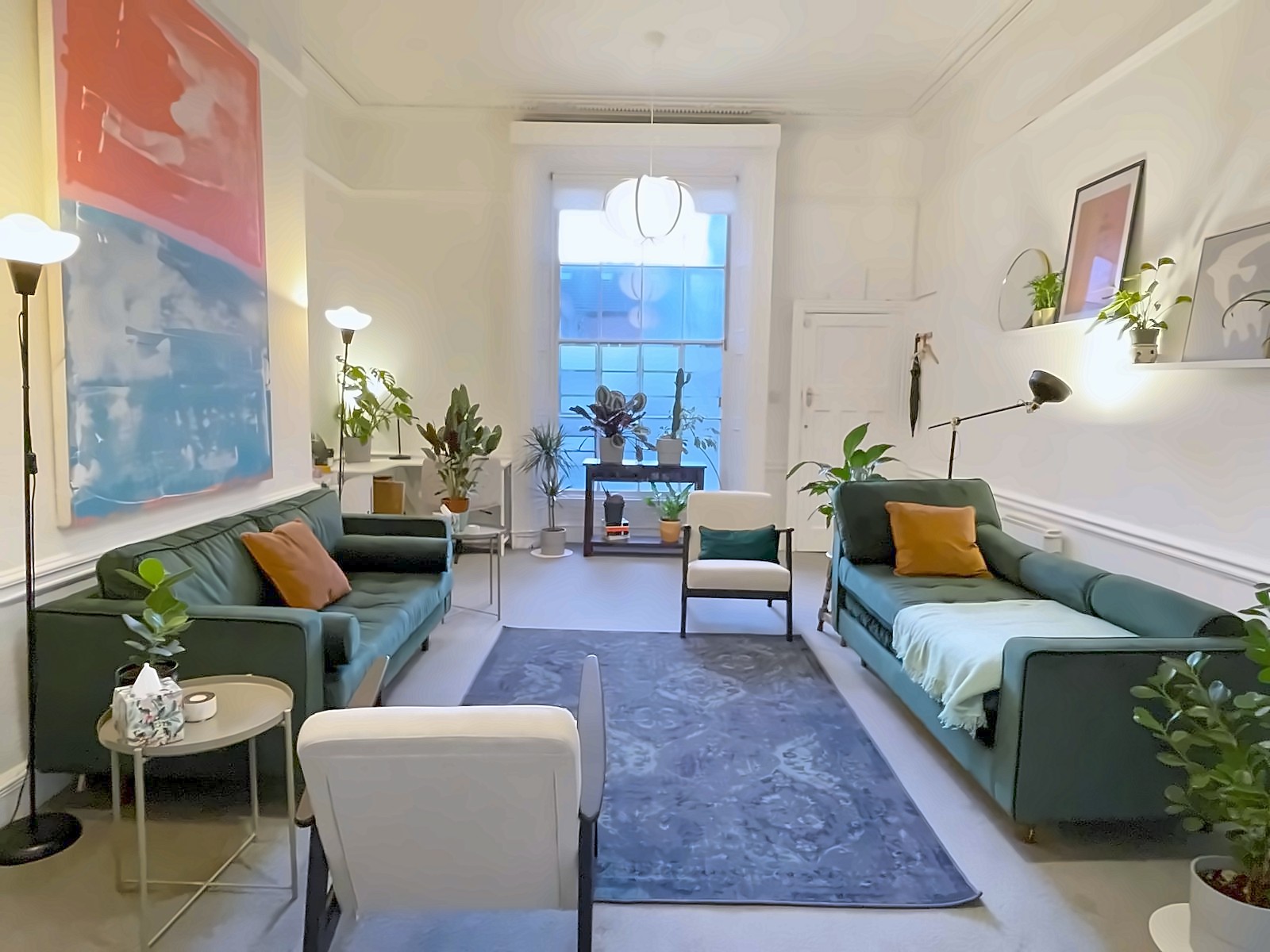 The consulting room, with high ceilings and a tall Georgian window